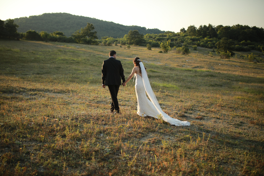 Married Couple Walking on Grassland